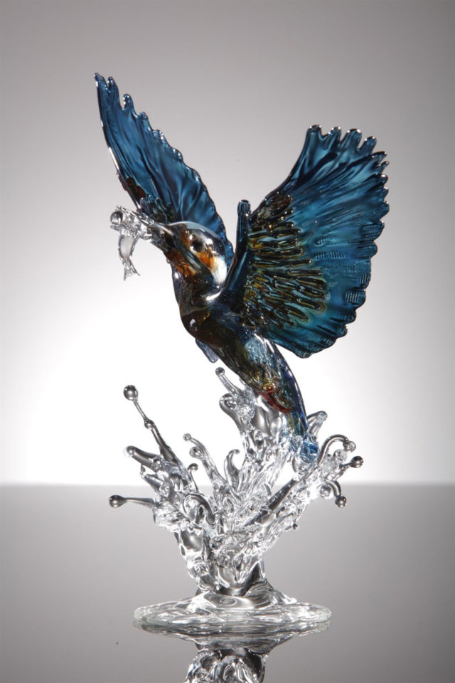 Kingfisher flying up out of water